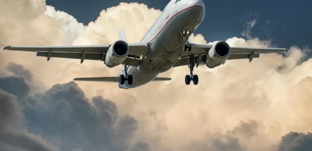 Traveler preparing documents and luggage for international travel.